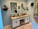 Bathroom featuring a double vanity with white cabinets and granite countertops, as well as two mirrors at 323 Dewpoint Ct # 35, Marietta, GA 30064