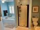 Bathroom features a shower and a tub with a window and white shutters that let natural light in at 323 Dewpoint Ct # 35, Marietta, GA 30064