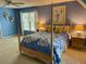 Bedroom with a four-poster bed, blue walls, and a ceiling fan for added comfort at 323 Dewpoint Ct # 35, Marietta, GA 30064
