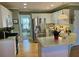 Bright eat-in kitchen with white cabinets, stainless steel appliances, and hardwood floors at 323 Dewpoint Ct # 35, Marietta, GA 30064
