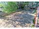 Large backyard with mature trees and a partial fence provides a serene outdoor space at 5685 Commons Ln, Alpharetta, GA 30005