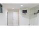 A full wall mirror reflects light and enhances the size of this basement bonus room at 5685 Commons Ln, Alpharetta, GA 30005