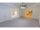 Expansive finished basement area with neutral carpet, doors, and an open layout with an intriguing room beyond at 5685 Commons Ln, Alpharetta, GA 30005