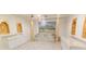 Grand room with decorative wall paintings, marble stair case, sink and cabinets and decorative columns at 5685 Commons Ln, Alpharetta, GA 30005