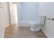 Clean bathroom with a tub and toilet at 5685 Commons Ln, Alpharetta, GA 30005