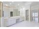 Bright bathroom featuring double vanity, granite countertops, and large mirror at 5685 Commons Ln, Alpharetta, GA 30005