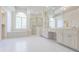 Bright and airy bathroom features a double vanity, walk-in shower, and separate soaking tub with large window at 5685 Commons Ln, Alpharetta, GA 30005