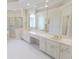 Bright bathroom featuring double vanity, granite countertops, large mirror, soaking tub, and glass enclosed shower at 5685 Commons Ln, Alpharetta, GA 30005