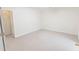 Neutral room with carpet, white walls and trim, featuring an open closet and an adjacent room beyond the open door at 5685 Commons Ln, Alpharetta, GA 30005