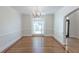 Dining room featuring hardwood floors, chandelier, large window, and elegant trim at 5685 Commons Ln, Alpharetta, GA 30005