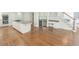 Kitchen featuring an island, stainless steel appliances, hardwood floors, and staircase at 5685 Commons Ln, Alpharetta, GA 30005