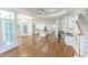 Open floor plan kitchen with island, bar, hardwood floors, and large windows at 5685 Commons Ln, Alpharetta, GA 30005