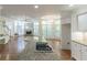 Kitchen island with cooktop, hardwood floors, and an open view to the living room at 5685 Commons Ln, Alpharetta, GA 30005