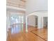 Open-concept living area with hardwood floors, archways, high ceilings, and a bay window at 5685 Commons Ln, Alpharetta, GA 30005