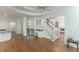 Open living space with hardwood floors, built-in bar area, and staircase to upper level at 5685 Commons Ln, Alpharetta, GA 30005