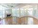 Expansive living room boasts hardwood floors, fireplace, and large windows with natural light at 5685 Commons Ln, Alpharetta, GA 30005