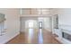 Spacious living area with fireplace, hardwood floors, and staircase to the second floor at 5685 Commons Ln, Alpharetta, GA 30005