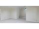 Open living area with carpet, a ceiling fan, and neutral paint at 5685 Commons Ln, Alpharetta, GA 30005
