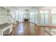 Bright living room with hardwood floors, fireplace, and large windows offers great natural light at 5685 Commons Ln, Alpharetta, GA 30005