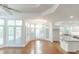 Spacious living area with hardwood floors, kitchen, dining area, and many windows at 5685 Commons Ln, Alpharetta, GA 30005