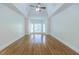 Spacious main bedroom featuring hardwood floors, ceiling fan, and lots of natural light at 5685 Commons Ln, Alpharetta, GA 30005
