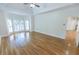 Bright main bedroom featuring hardwood floors, tray ceilings, and lots of natural light at 5685 Commons Ln, Alpharetta, GA 30005