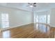 Large main bedroom featuring hardwood floors, tray ceilings, and lots of natural light at 5685 Commons Ln, Alpharetta, GA 30005
