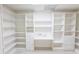 Custom storage system featuring open shelving and a built-in desk with drawers for efficient organization and utility at 5685 Commons Ln, Alpharetta, GA 30005