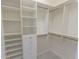Custom walk-in closet with built-in shelves, drawers, and rods for organized storage at 5685 Commons Ln, Alpharetta, GA 30005
