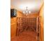 Custom wine cellar features a vintage chandelier, wood paneling and custom wine racks at 5685 Commons Ln, Alpharetta, GA 30005