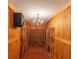 Custom wine cellar features a vintage chandelier, wood paneling and custom wine racks at 5685 Commons Ln, Alpharetta, GA 30005