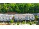 Aerial view of townhomes boasting well-maintained lawns, professional landscaping, and inviting sidewalks at 7850 Willoughby Ct, Alpharetta, GA 30005