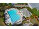 Aerial view of a community pool with lounge chairs, clubhouse, and landscaping at 7850 Willoughby Ct, Alpharetta, GA 30005