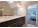 Elegant bathroom with a double vanity, granite countertops, and an ensuite view into the Primary bedroom at 7850 Willoughby Ct, Alpharetta, GA 30005