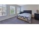 Bedroom featuring natural light from two large windows and a bed with stylish blue patterned covers at 7850 Willoughby Ct, Alpharetta, GA 30005