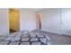 Cozy bedroom with neutral walls, plush carpeting, and ample closet space for storage at 7850 Willoughby Ct, Alpharetta, GA 30005