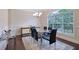 Bright dining room featuring a glass table, modern decor, and large window views at 7850 Willoughby Ct, Alpharetta, GA 30005