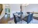 Stylish dining room with glass table, staircase, and hardwood floors at 7850 Willoughby Ct, Alpharetta, GA 30005