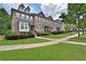 Brick front townhomes with manicured lawns and sidewalks at 7850 Willoughby Ct, Alpharetta, GA 30005