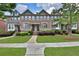 Inviting brick townhome with well-maintained landscaping and charming curb appeal in a desirable community at 7850 Willoughby Ct, Alpharetta, GA 30005