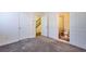 Hallway view with carpet, doors and view to staircase and adjacent bathroom at 7850 Willoughby Ct, Alpharetta, GA 30005
