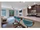 Stylish kitchen with granite countertops, breakfast bar seating, and an open view of the living area and outdoor patio at 7850 Willoughby Ct, Alpharetta, GA 30005