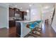 Modern kitchen featuring dark wood cabinets, stainless steel appliances, granite countertops, and a convenient breakfast bar at 7850 Willoughby Ct, Alpharetta, GA 30005