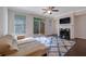 Cozy living room with a fireplace, hardwood floors, and a sliding door to a deck at 7850 Willoughby Ct, Alpharetta, GA 30005