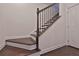 Staircase showcases beautiful dark wood steps with white risers and a wooden banister at 7850 Willoughby Ct, Alpharetta, GA 30005