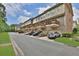 Street view of townhomes with garages, driveways, and multiple levels of private balconies at 7850 Willoughby Ct, Alpharetta, GA 30005