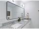 Bright bathroom showcasing dual vanities with granite countertops, modern framed mirror, and sleek fixtures at 101 Stroud Se Dr, Mableton, GA 30126