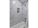 This bathroom features a shower and tub with marble style tile and a convenient niche at 101 Stroud Se Dr, Mableton, GA 30126