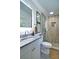 Modern bathroom with granite countertop vanity, wood-look shower, glass partition, and stone floor at 101 Stroud Se Dr, Mableton, GA 30126