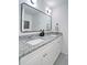 Updated bathroom features dual vanity with granite counters and a modern framed mirror at 101 Stroud Se Dr, Mableton, GA 30126